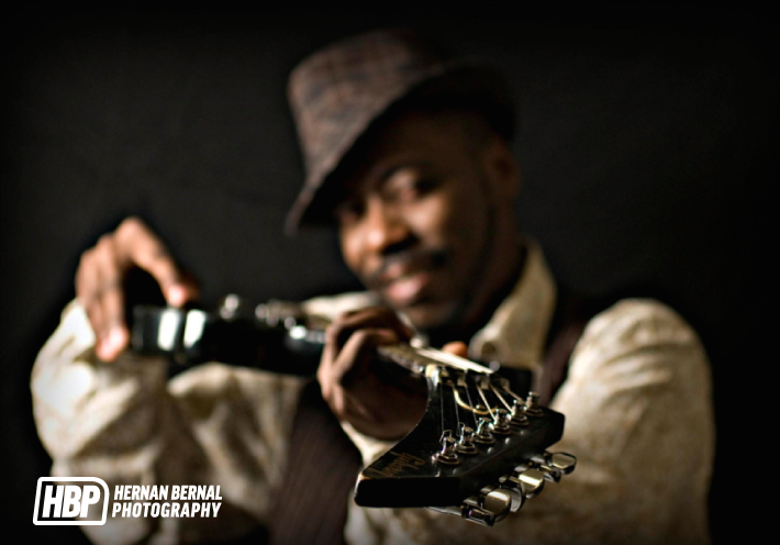 hernan-bernal-photography-fknhard-magazine-closeup-photoshoot-male-model-guitar-fedora-hat-smile-guitar-strings